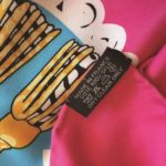 A crude fake label is wrong and incorrectly stitched onto the scarf