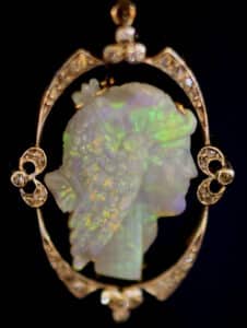 The profile of a striking classical beauty is masterfully hand-carved in white onyx, highlighted by a subtle black aura, in this exquisite Edwardian pendant necklace photo: Lang Antiques