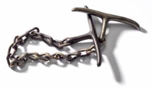 Come-along, 1874 – This one-handed restraint, a pre-cursor to handcuffs, was used by wrapping the chain around a suspect’s wrist and holding the two bars between the officer’s fingers.