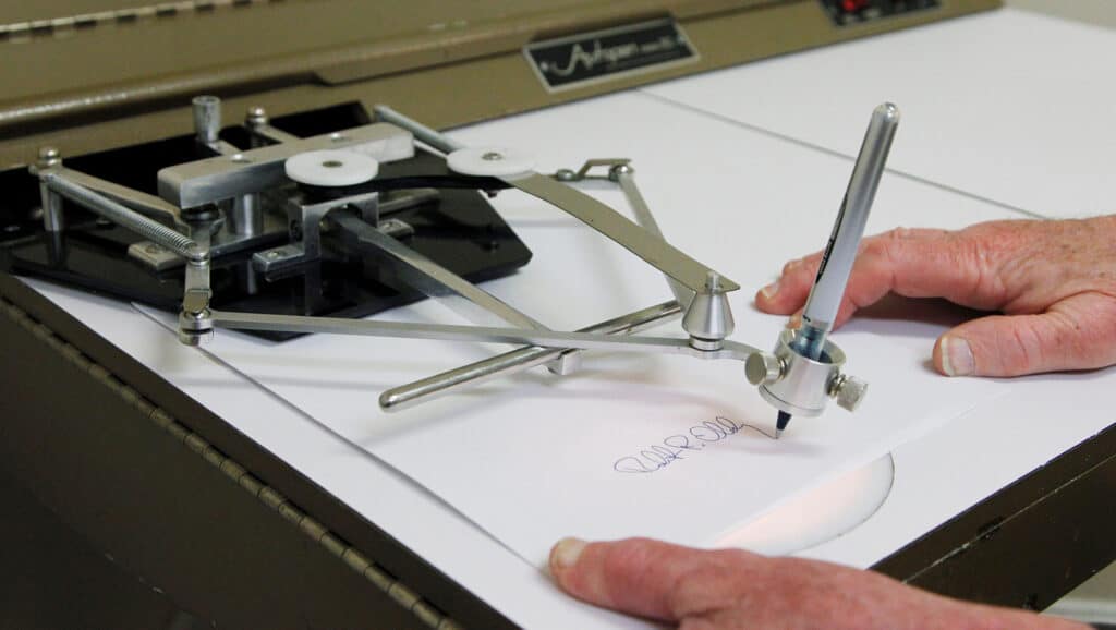 This 2011 photo depicts Bob Olding of Damilic Corp, a leading present-day manufacturer of signature machines, demonstrating the vintage Autopen Model 80. The machine uses levers and your favorite pen to duplicate programmed signatures, and while this can be a lifesaver for public officials, many in the government still use it sparingly. Though President Bush received a Justice Department Ruling in 2005 to sign a bill via autopen, he opted not to, and went out of his way to sign in person. Photo: via USA Today and Damilic Corp, Associated Press, 2011
