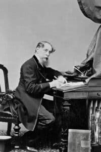 Charles Dickens, in 1858, at his writing desk. photo: Old Photo Archive