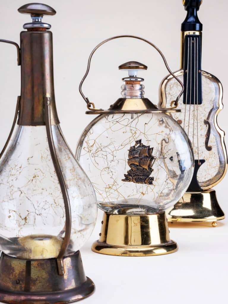 but there is a grouping that has similar styling with metal embellishments and gold lustre squiggles on the glass. Most of them play How Dry I Am.