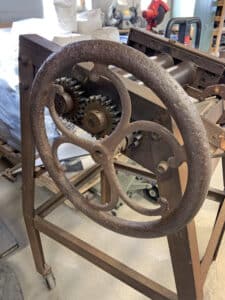 The “Roller Thing,” a hand-made tool used to press glass and “get the bubbles out” with an antique turning wheel pulled from the ground.