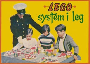 By 1955, Godtfred came up with the first in a long line of LEGO “System of Play” sets which focused on a single town or village scene. Godtfred is seen here in the police costume with his son Kjeld, daughter Gunhild, and their cousin Jorgen.