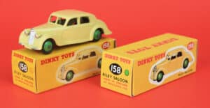 Side by side: Original mid-1950s Dinky Toys Riley with its original box on left, next to a reproduction box made by D.R.R.B.