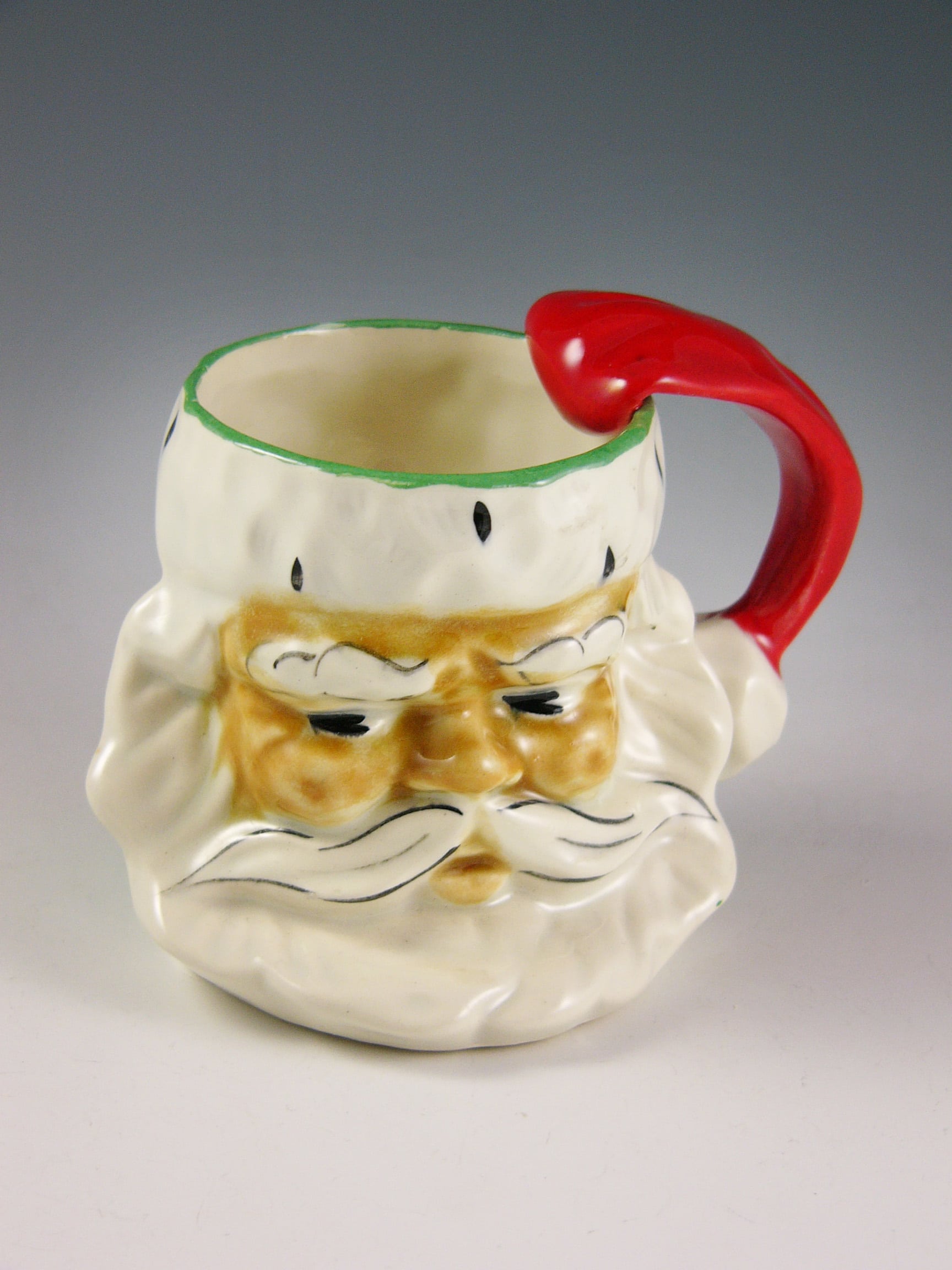 Left: Ready to serve up Christmas punch: a somewhat solemn Santa mug, marked “Riddell, 1951.”