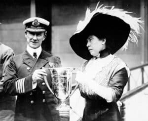 Captain Arthur Henry Rostron of the Carpathia receiving a silver cup award from Molly Brown for his role in the rescue of Titanic survivors.