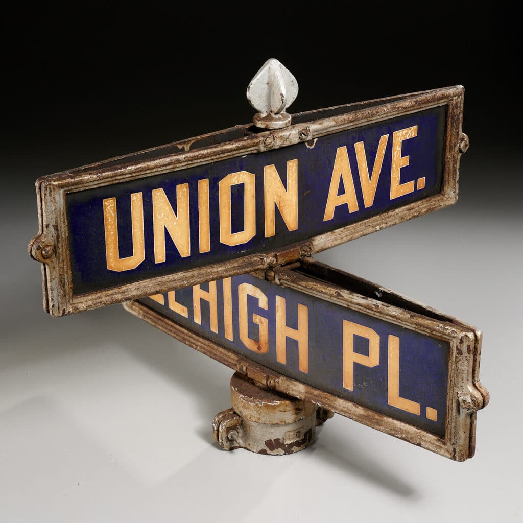 Sold at MilleaBros.com, this cross sign shows Union Avenue and Lehigh Place. First half 20th c., probably Irvington, NJ, double-sided metal signs bolted to intersection street post cap, 16.5” h x 20.5” w x 20.5” d. Sold price was $150, just over the estimate of $80-$125.