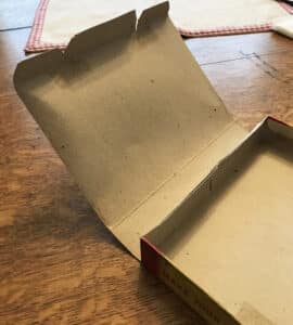 “Before” photo of the lid of the Crystal Car box, showing the warping.