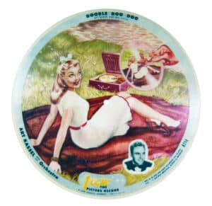 #R714, Doodle Doo Doo shows one of the turntables especially designed so that stores could highlight Vogue records. Rather than being on a standard horizontal plane, the Vogue turntable was tilted. The disc’s picture could then be enjoyed as the record spun. $40-50.