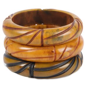 Three carved and over dyed Bakelite bangle bracelets have been popular accessories since the 1930s.