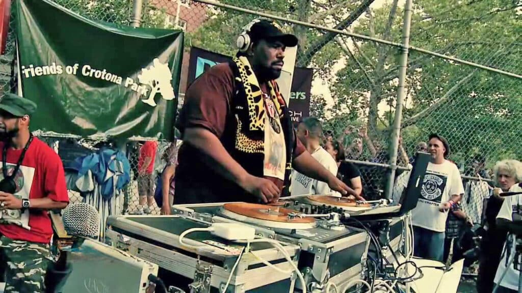 Afrika Bambaataa performing with his turntables at an outside benefit.