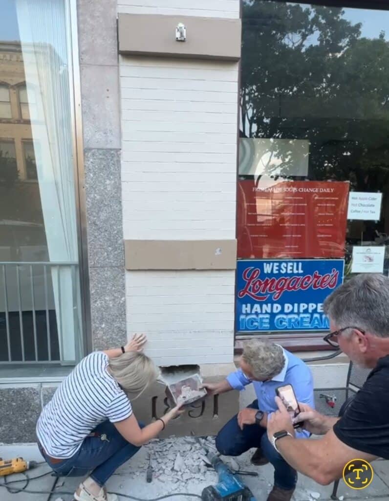 Father-daughter duo Lou and Lisa Pektor, removing the box 
from the cornerstone.