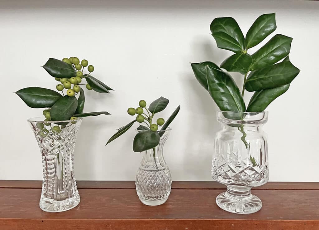 A sprig or two from the garden captures the holiday spirit when displayed in a small Waterford vase.