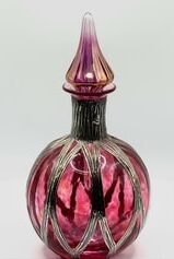 74 Excellent example of Sileda Wales cranberry and silver perfume bottle
with assay marks, 6 inches tall