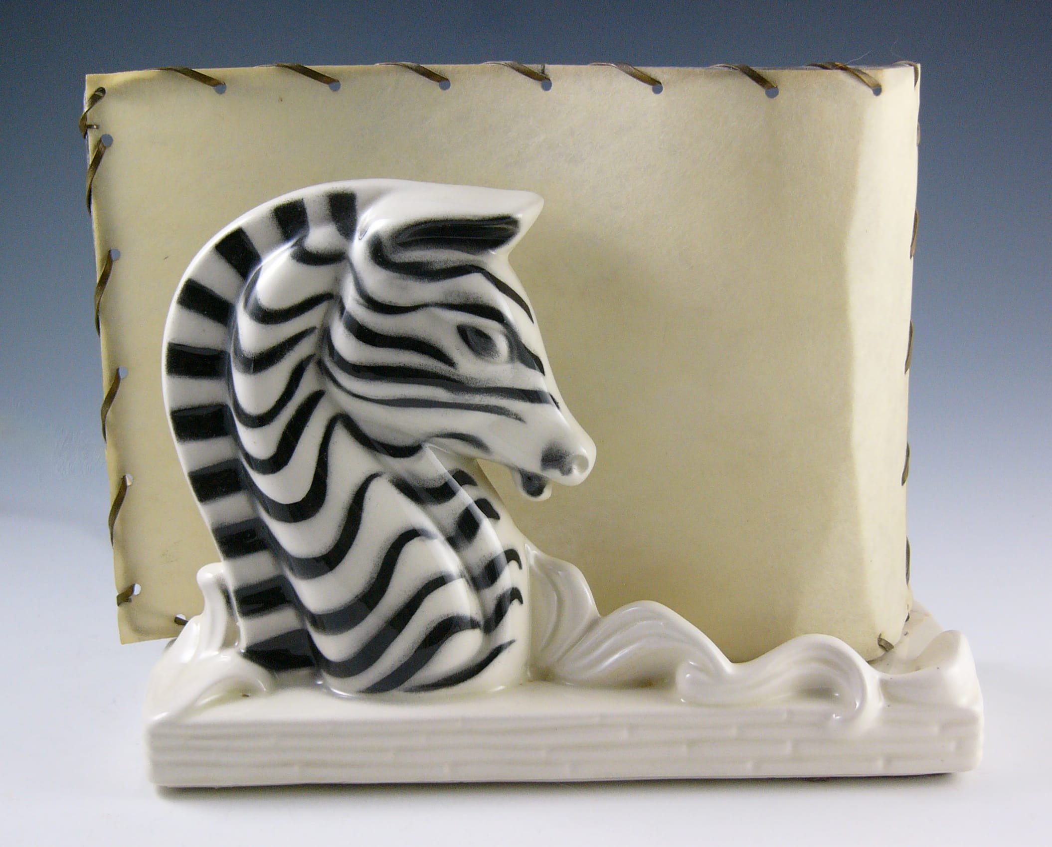 zebra head, nestled against a parchment-like shade.