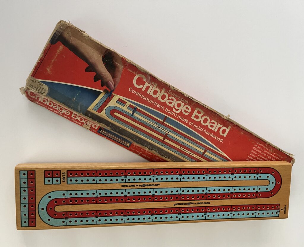 At left: A vintage cribbage board 
such as this one, when not in use, 
could double as a wall hanging.