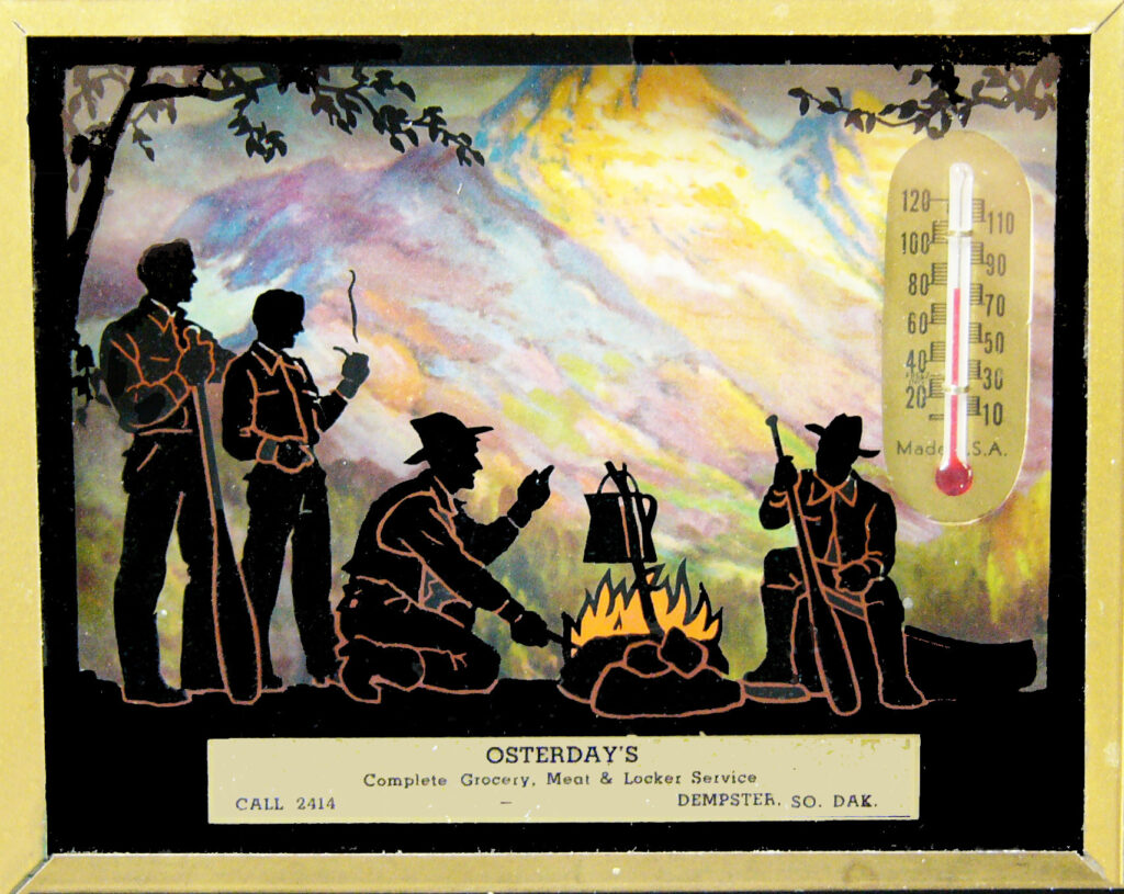 Campfire cooking after a long day. The thermometer/calendar courtesy of “Osterday’s Grocery, Dempster, SD” also has a 1952 calendar on the back.