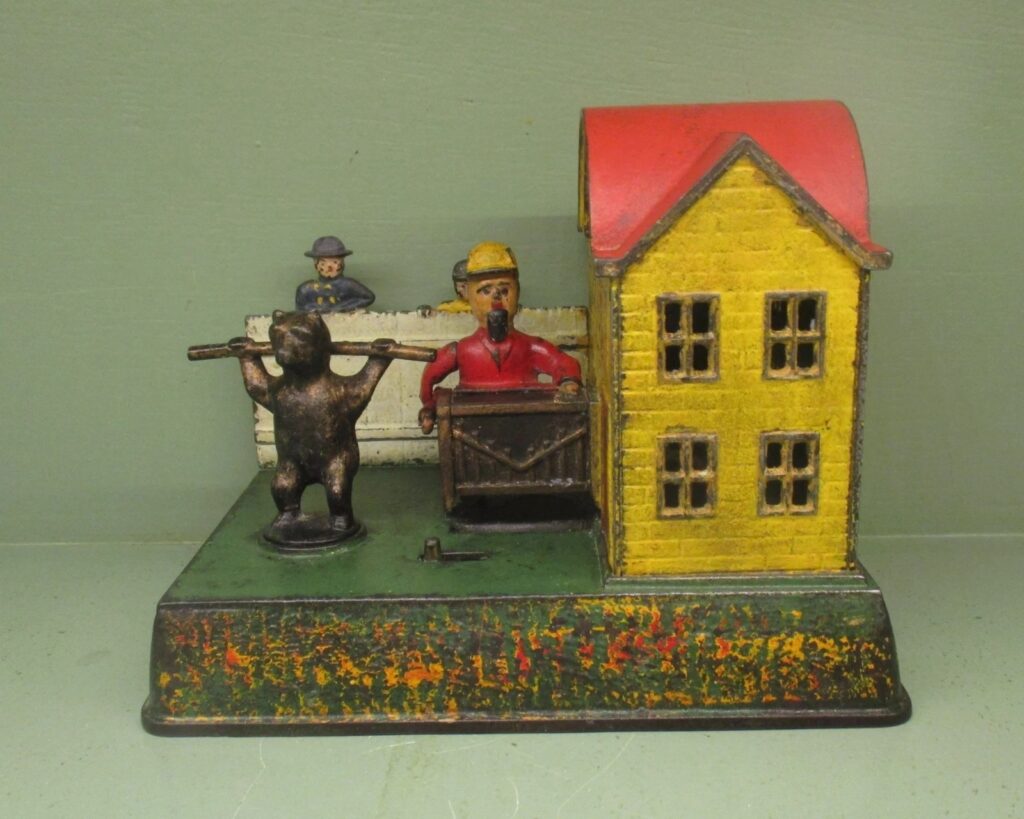 This is the ‘Organ Grinder and Performing Bear’ Mechanical Bank designed by Louis Kyser & Alfred Rex and manufactured by the Kyser & Rex Co., Philadelphia, PA.