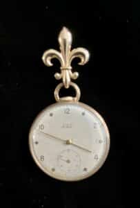 A gentleman’s pocket watch need not sit in a drawer, thanks to the purchase of a fleur-de-lis brooch.