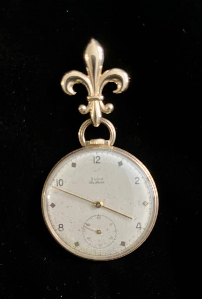 A gentleman’s pocket watch need not sit in a drawer, thanks to the purchase of a fleur-de-lis brooch.